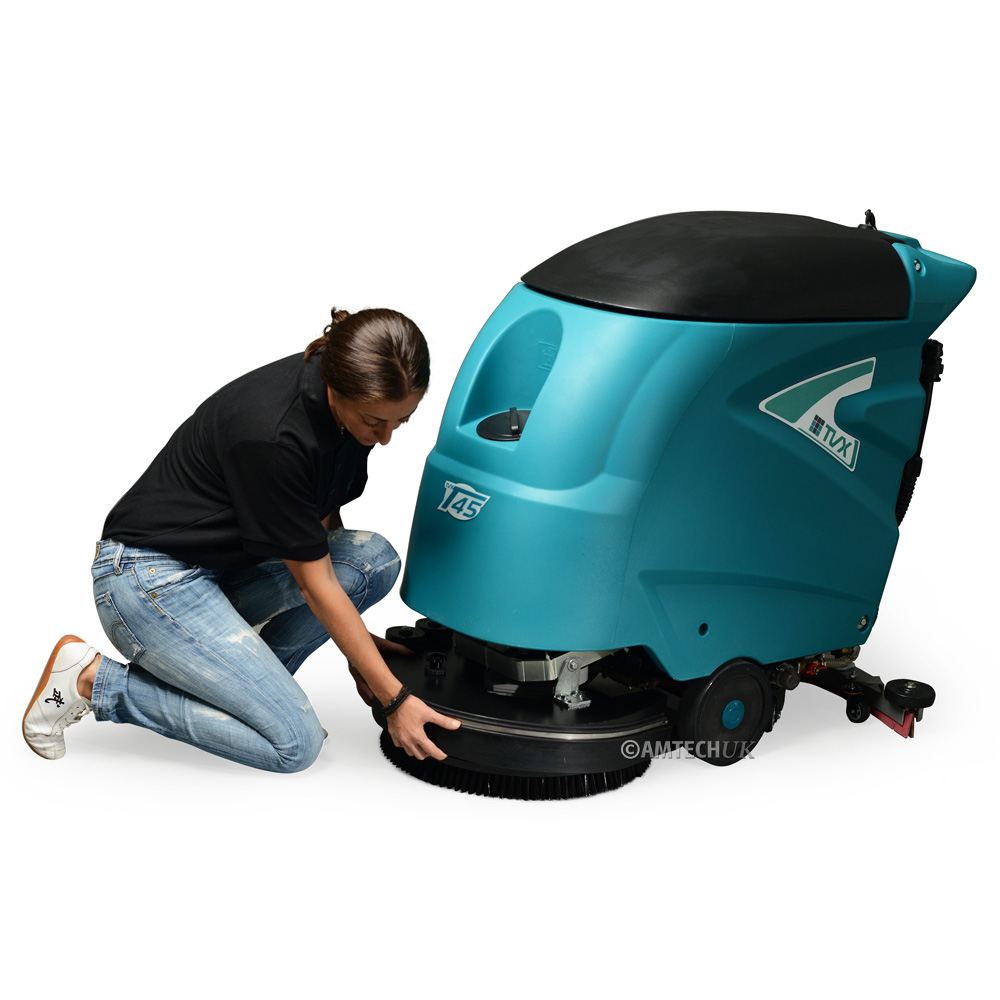 Woman changing brush on the TVX T45B walk behind scrubber-dryer.